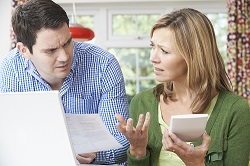 worried couple discussing finances_250.jpg